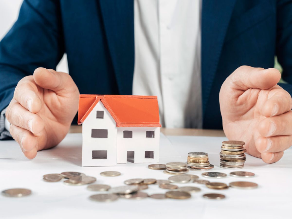close-up-hands-with-coins-house