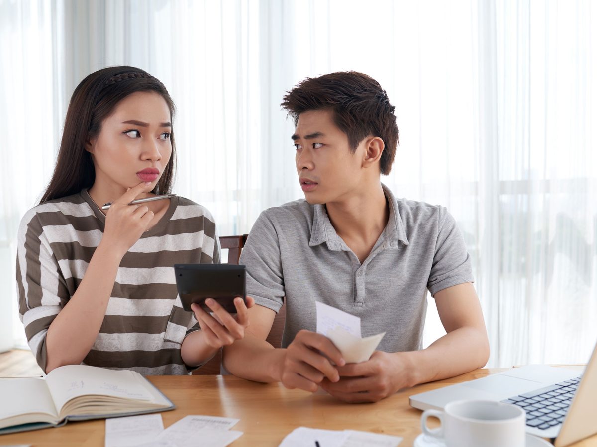 unhappy-young-family-calculating-expenses-going-bankrupt